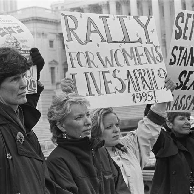 women holding signs for womens rights