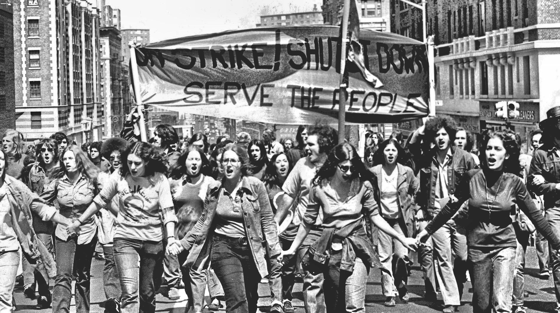 On Strike banner people protesting