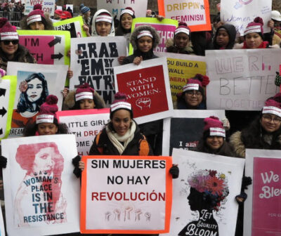 cropped women with pink protest signs