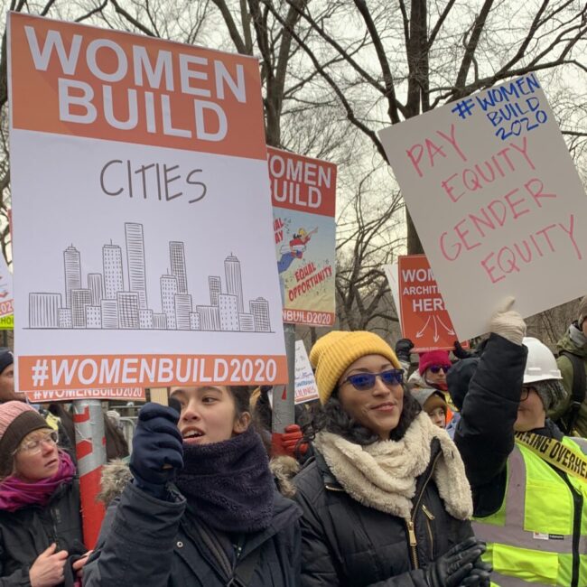 women marching labor signs